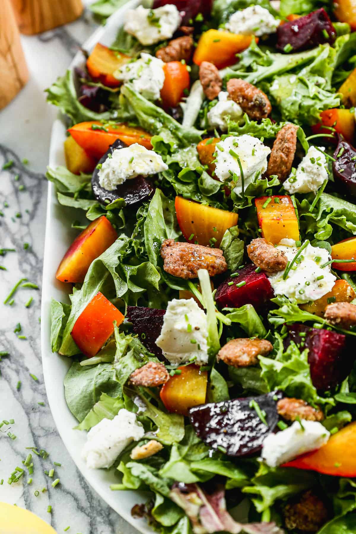 A close up image of an easy beet salad with roasted beets, walnuts, and whipped goat cheese.