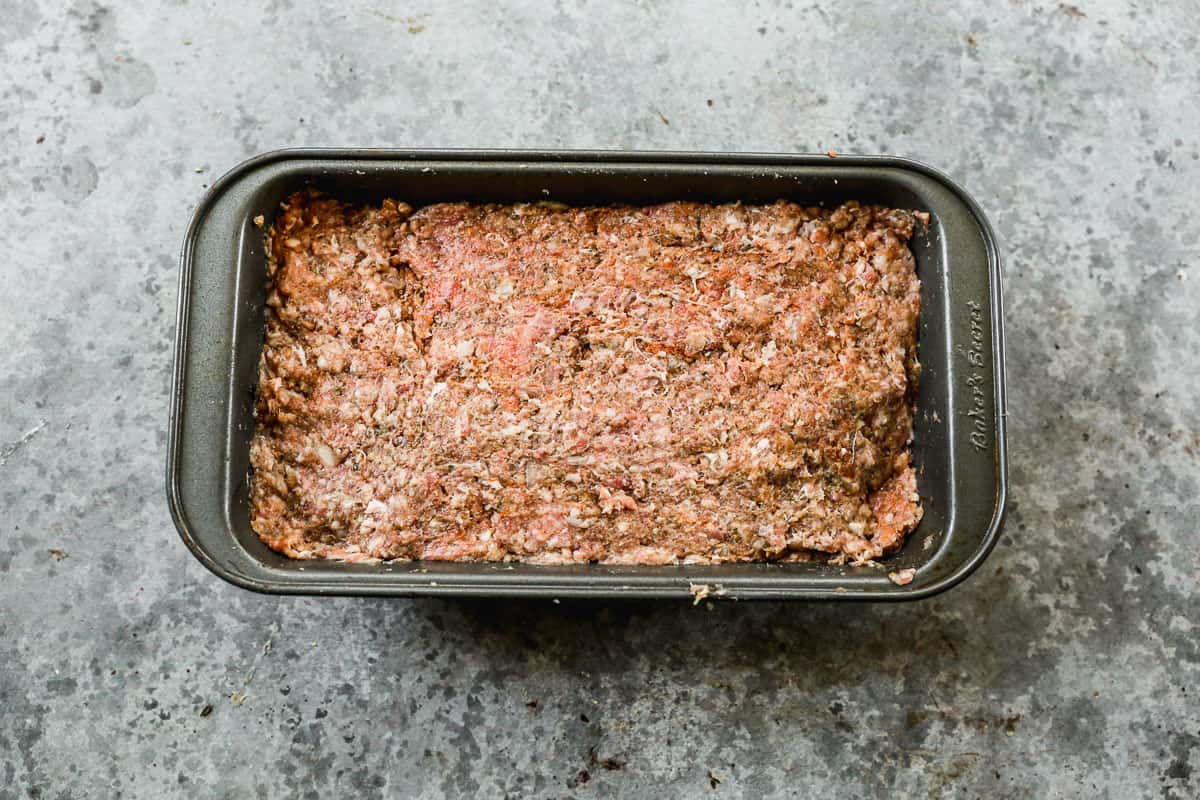 An easy gyro meat recipe in a loaf pan, ready to bake.