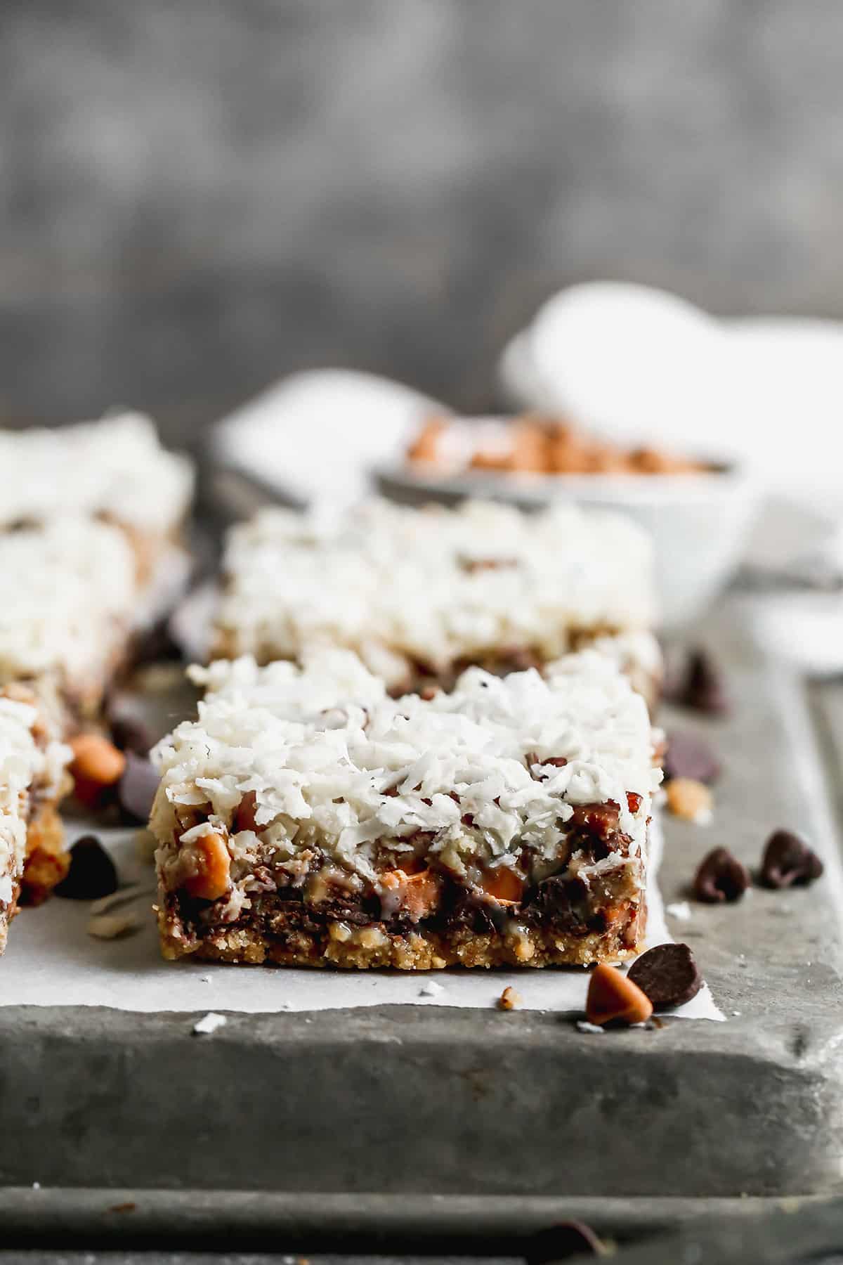 The best Magic Bars recipe cut into bars and placed on a baking sheet.