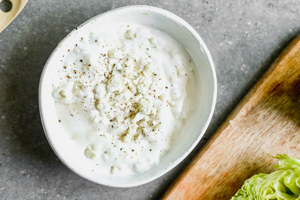 A small white bowl with a homemade blue cheese dressing. 