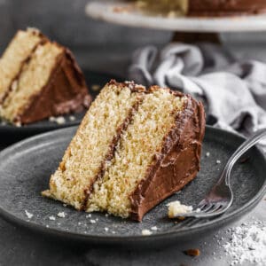 A slice of homemade Yellow Cake recipe with chocolate frosting, ready to enjoy.