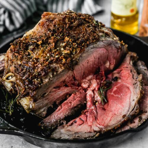 The best prime rib recipe with a few slices cut in preparation for serving.