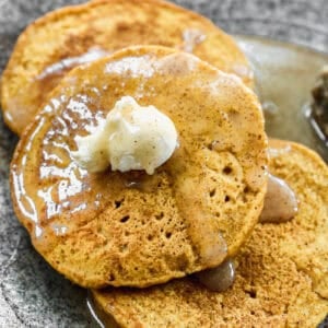 This easy Pumpkin Pancake recipe is topped with an easy cinnamon syrup. It's so delicious and perfect for Fall!