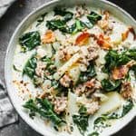 Save this creamy Zuppa Toscana recipe for a cozy homemade dinner. Italian sausage, potatoes, kale, bacon, and cream make a hearty soup with Olive Garden-inspired flavor. Includes stovetop, slow cooker, Instant Pot, and make-ahead instructions.
