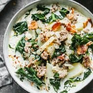 Save this creamy Zuppa Toscana recipe for a cozy homemade dinner. Italian sausage, potatoes, kale, bacon, and cream make a hearty soup with Olive Garden-inspired flavor. Includes stovetop, slow cooker, Instant Pot, and make-ahead instructions.