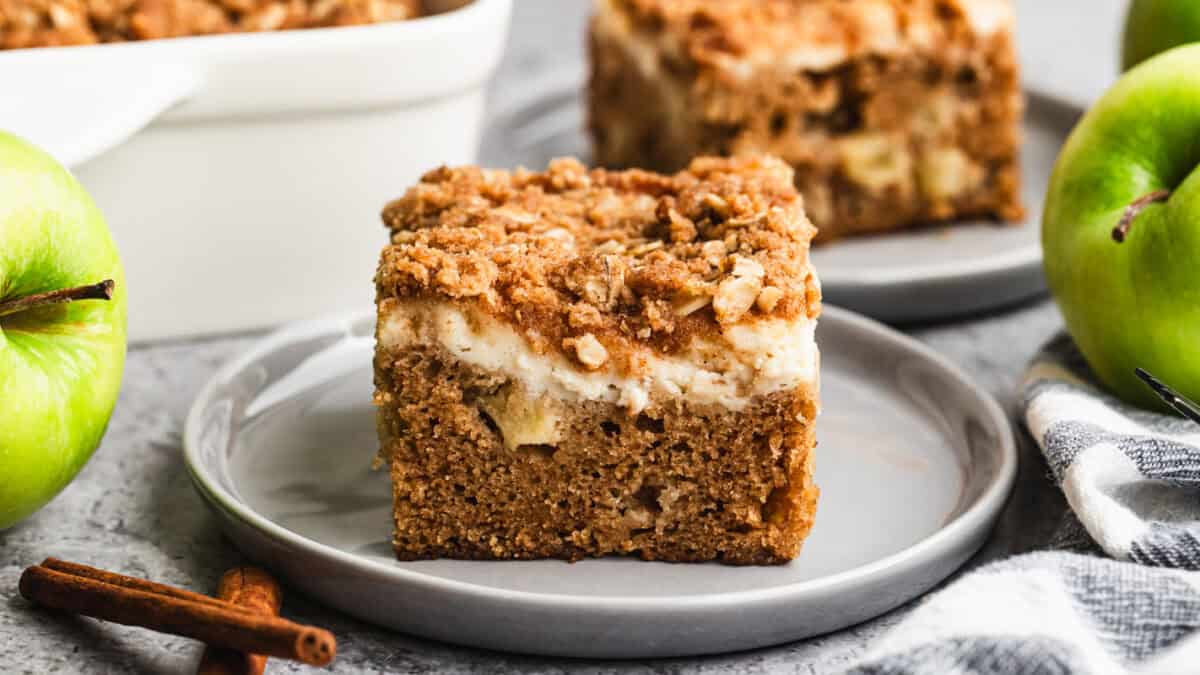 This easy Apple Coffee Cake has diced apples right in the batter, a cream cheese layer, and a crunchy streusel topping. It is a must-bake every Fall!