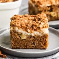 This easy Apple Coffee Cake has diced apples right in the batter, a cream cheese layer, and a crunchy streusel topping. It is a must-bake every Fall!