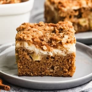 This easy Apple Coffee Cake has diced apples right in the batter, a cream cheese layer, and a crunchy streusel topping. It is a must-bake every Fall!