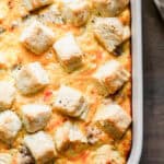 An easy Biscuits and Gravy Casserole recipe topped melted cheese and chunks of biscuits.