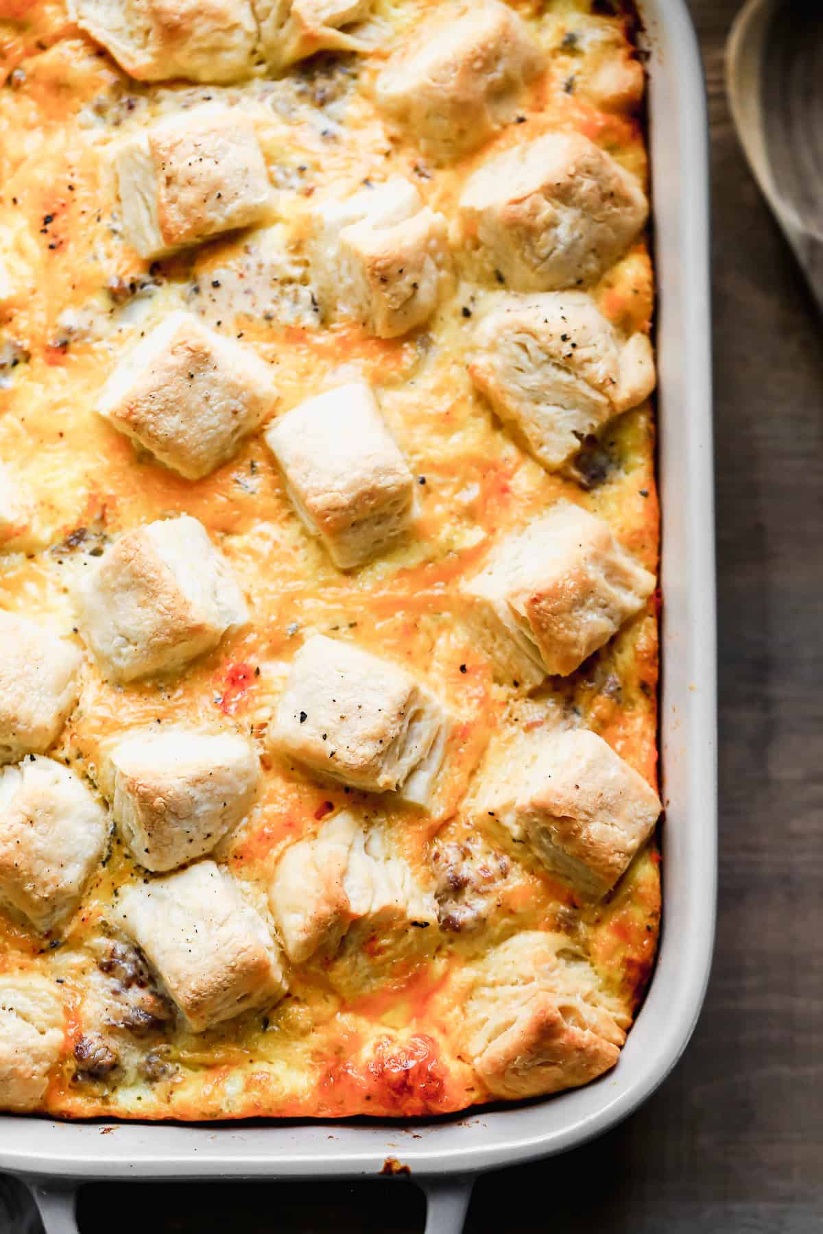 An easy Biscuits and Gravy Casserole recipe topped melted cheese and chunks of biscuits.