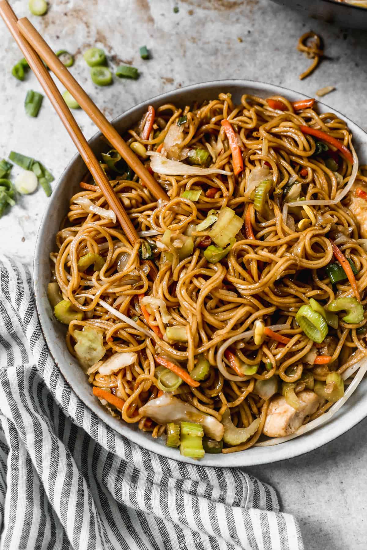 A bowl with an easy Chow Mein recipe with chicken and veggies, with chopsticks.