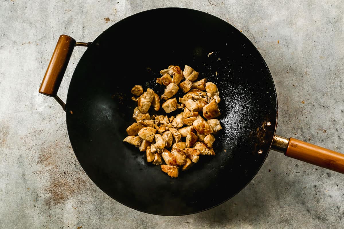 A wok with chicken sautéed until golden brown for the best chow mein recipe.