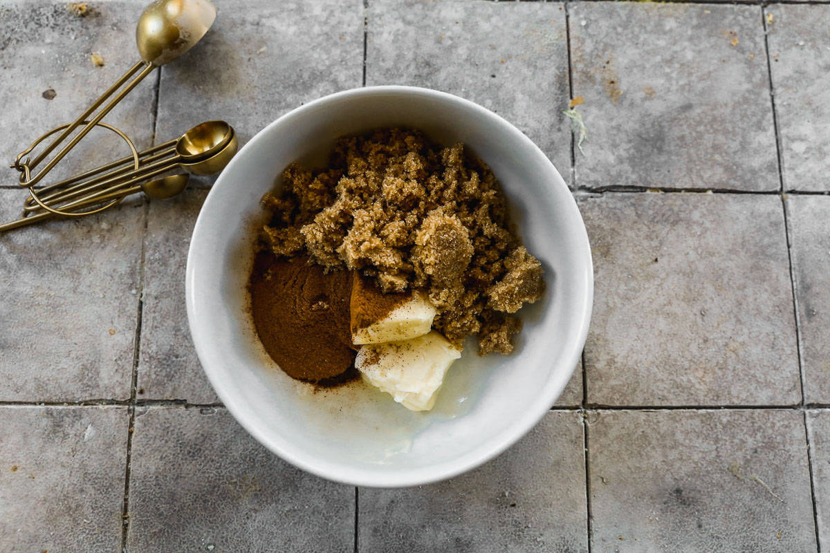 A bowl with butter, brown sugar, cinnamon, and nutmeg in a bowl.