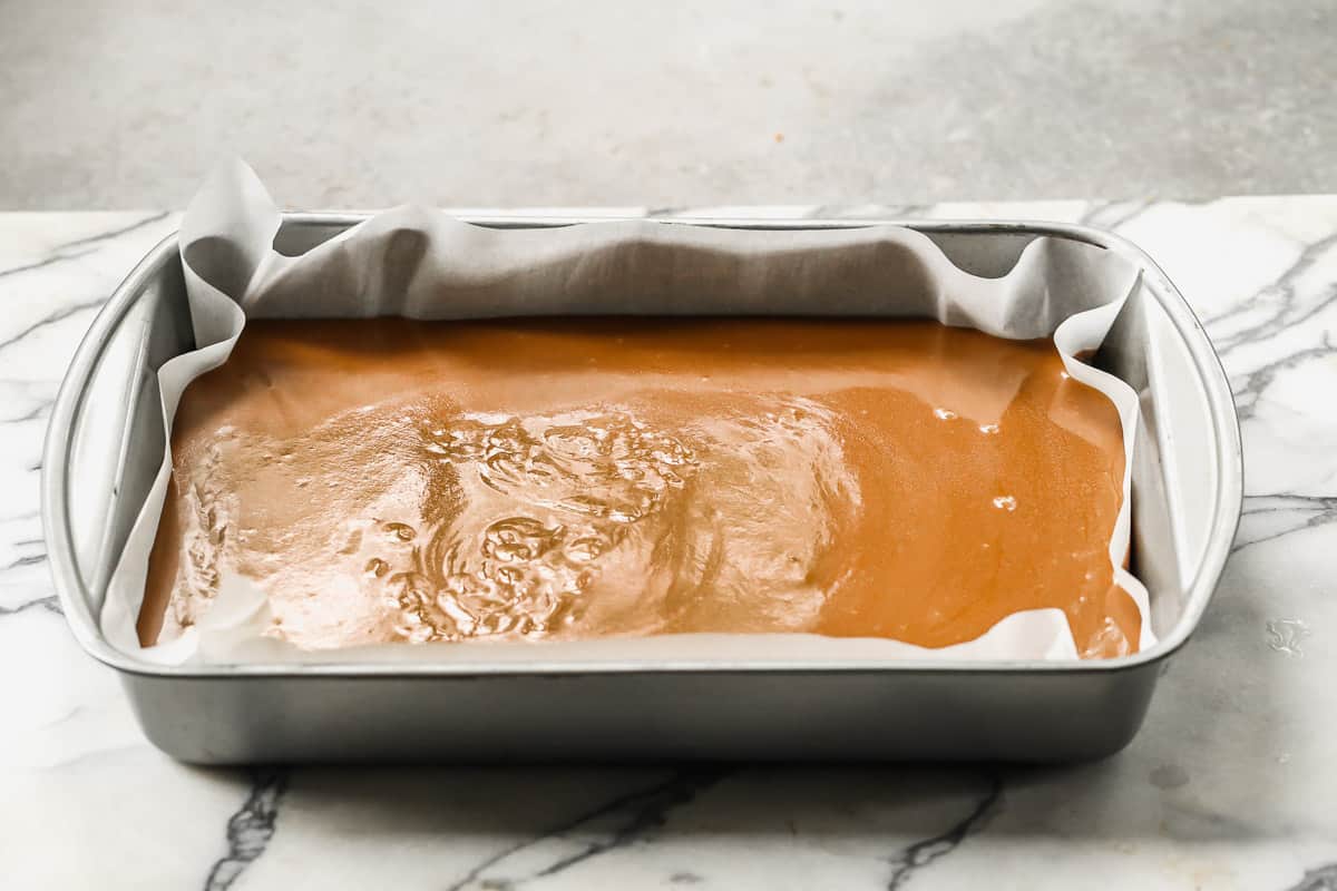 An easy caramel recipe poured in a 9x13 pan on top of parchment paper.