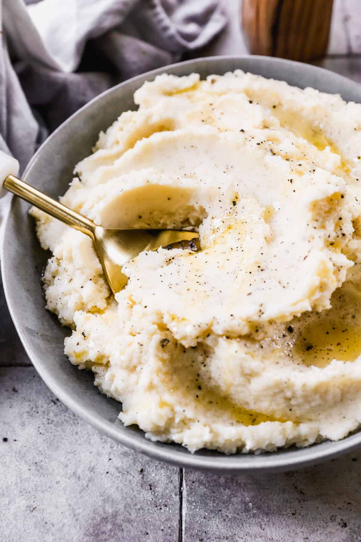A bowl of creamy mashed potatoes with a spoon, ready to serve.