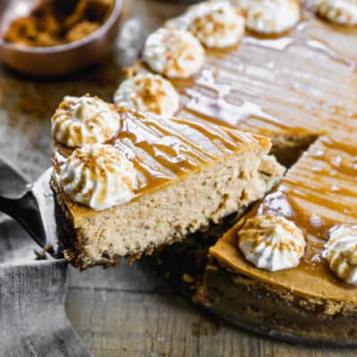 An easy Pumpkin Cheesecake with a slice being lifted.