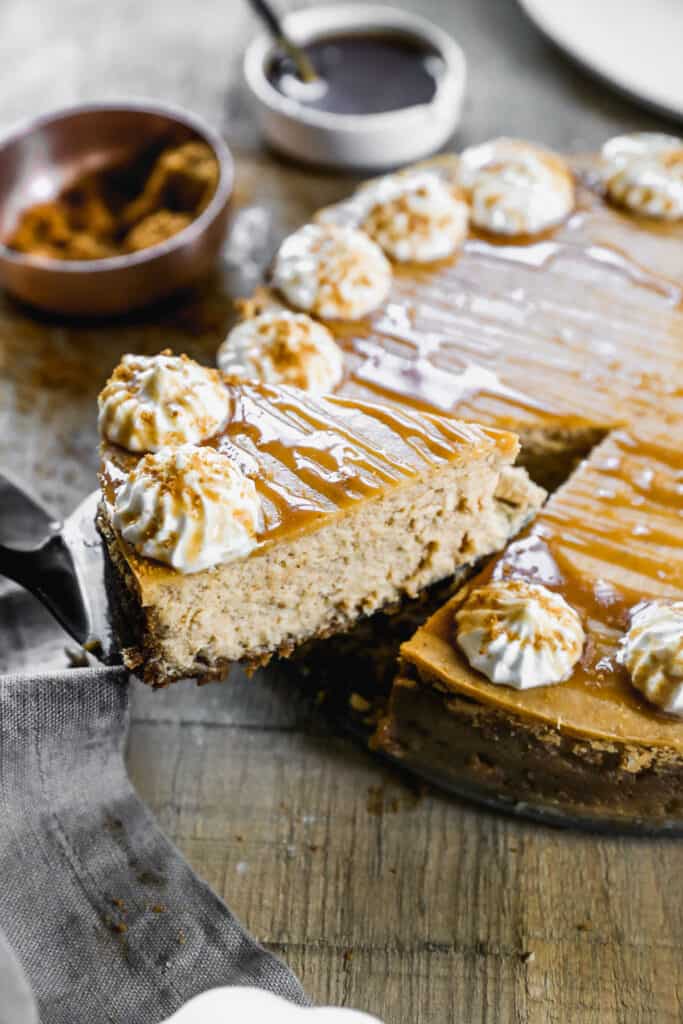An easy Pumpkin Cheesecake with a slice being lifted.