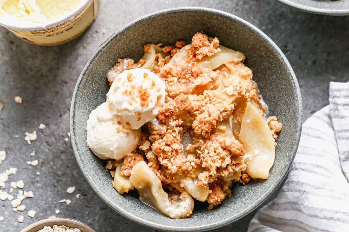 This easy Apple Crisp recipe has flavorful spiced apples and a buttery crumble baked until golden. Serve it with vanilla ice cream for a crowd pleasing fall treat!