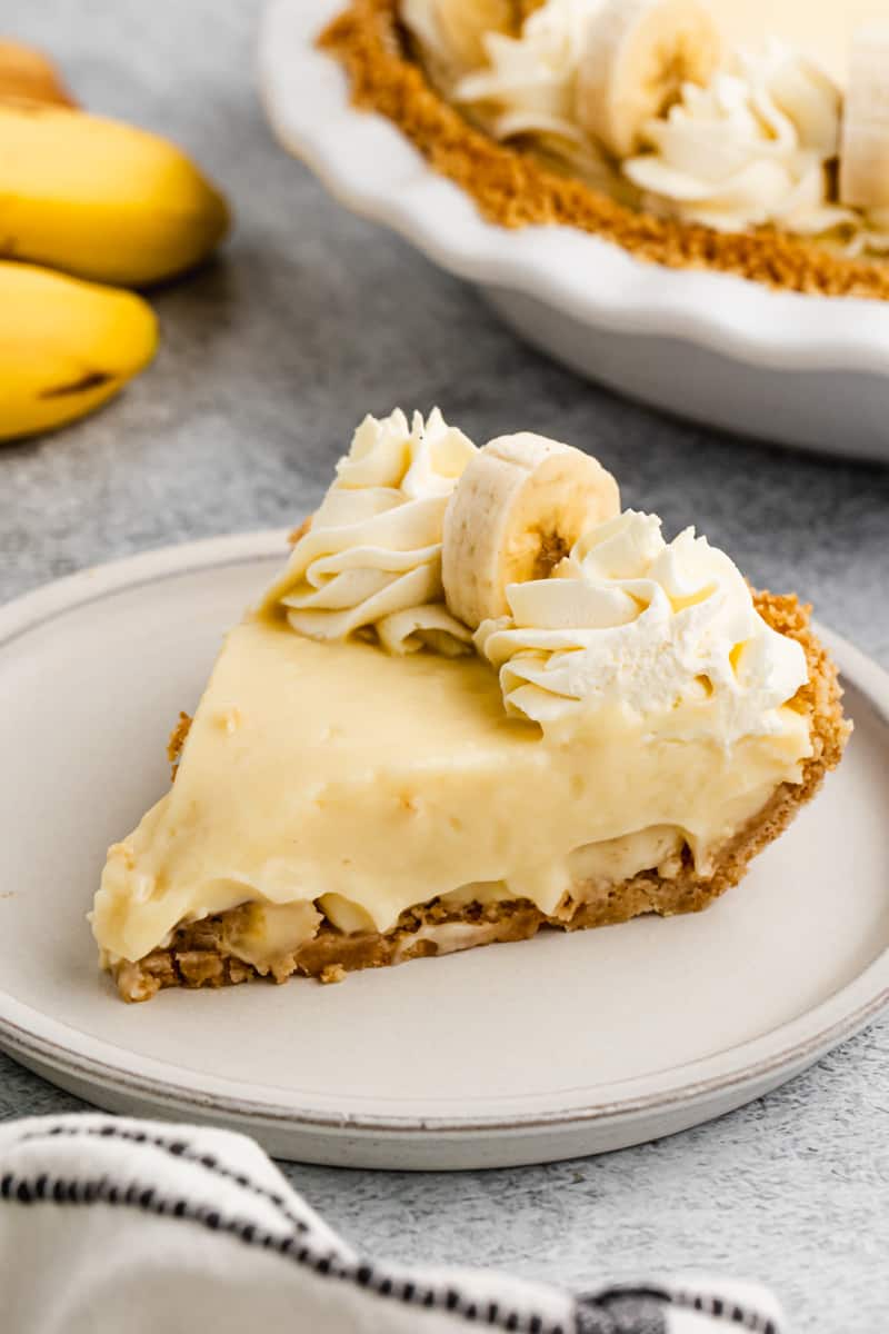 A slice of homemade Banana Cream Pie on a plate, ready to enjoy.