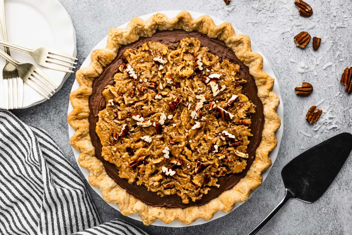 The best German Chocolate Pie recipe with a coconut pecan topping, ready to be sliced and served.