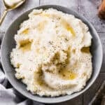 This easy Mashed Potatoes recipe will steal the show at dinner! They are better than the restaurant - light, fluffy, and perfect!