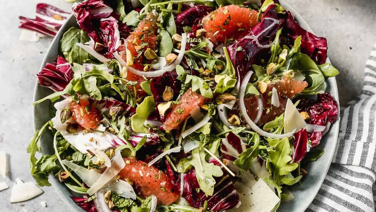 The best Radicchio Salad recipe has a delicious balsamic vinaigrette drizzled on a salad bed of radicchio, grapefruit, pistachios, and parmesan shavings. It's a showstopper and only takes 20 minutes!