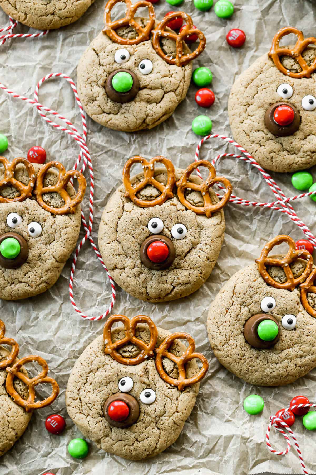 A bunch of easy Reindeer Cookies, made with pretzels, candy eyes, rolos, and m&m's on a homemade peanut butter cookie.