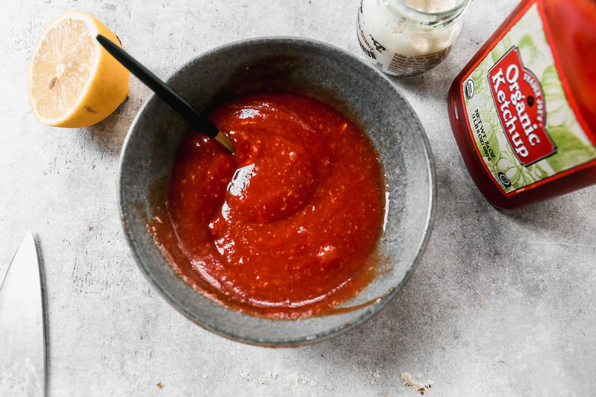 A cocktail sauce in a small bowl made with ketchup, lemon juice, and horseradish.