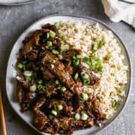 An easy Mongolian Beef recipe in a ginger garlic sauce served over rice, and topped with green onions.
