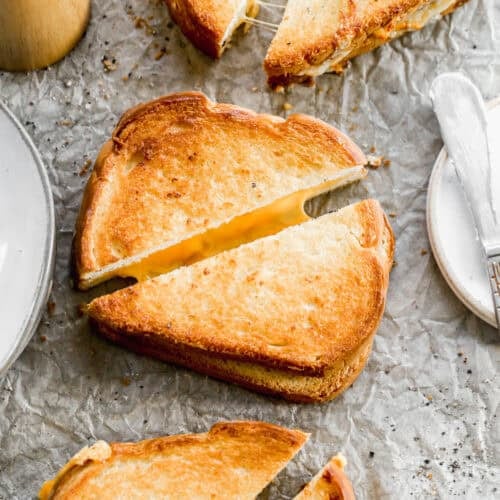 The best Air Fryer Grilled Cheese Sandwiches golden and crunchy and cut in half to show the melted center.
