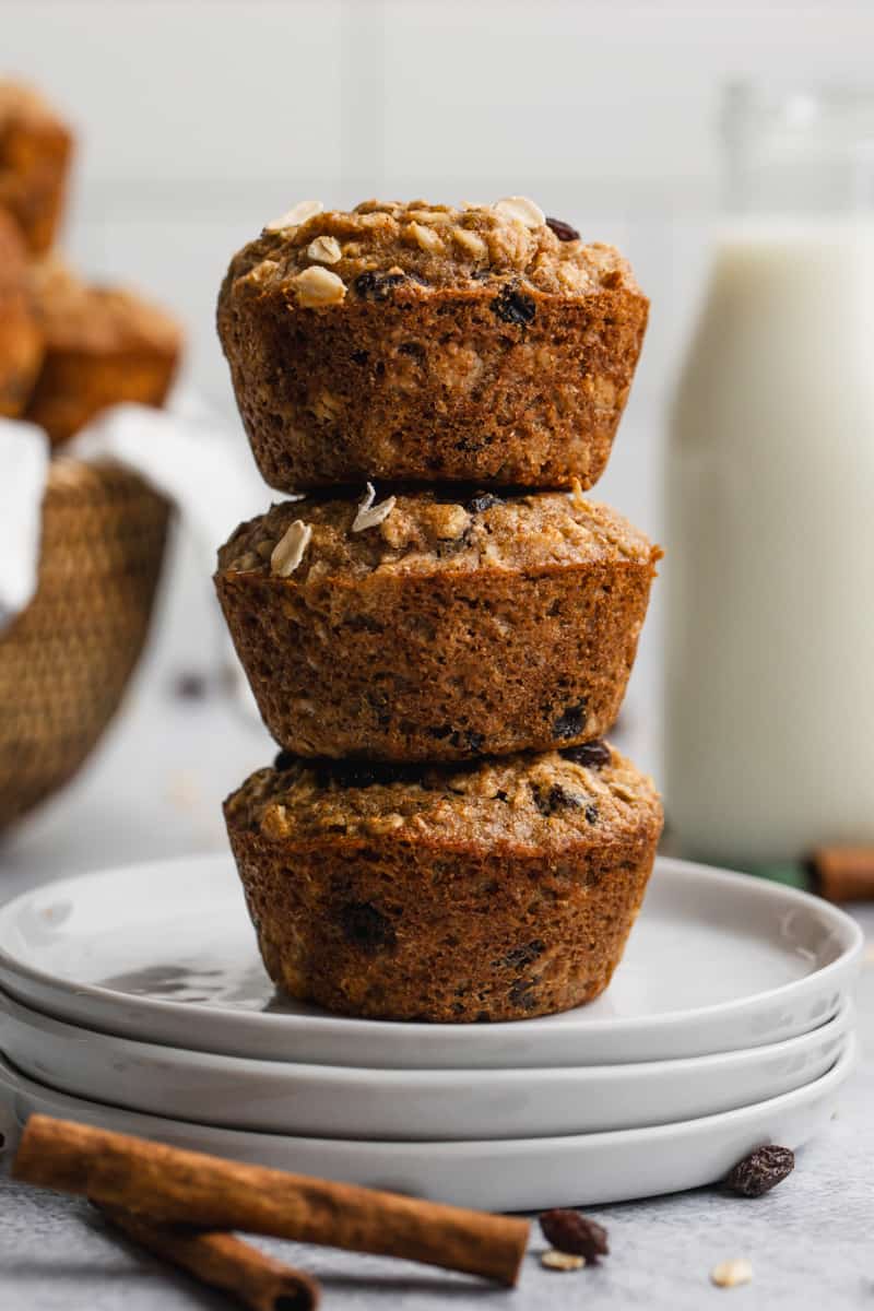 Three easy Applesauce Muffins with oats stacked on top of each other.