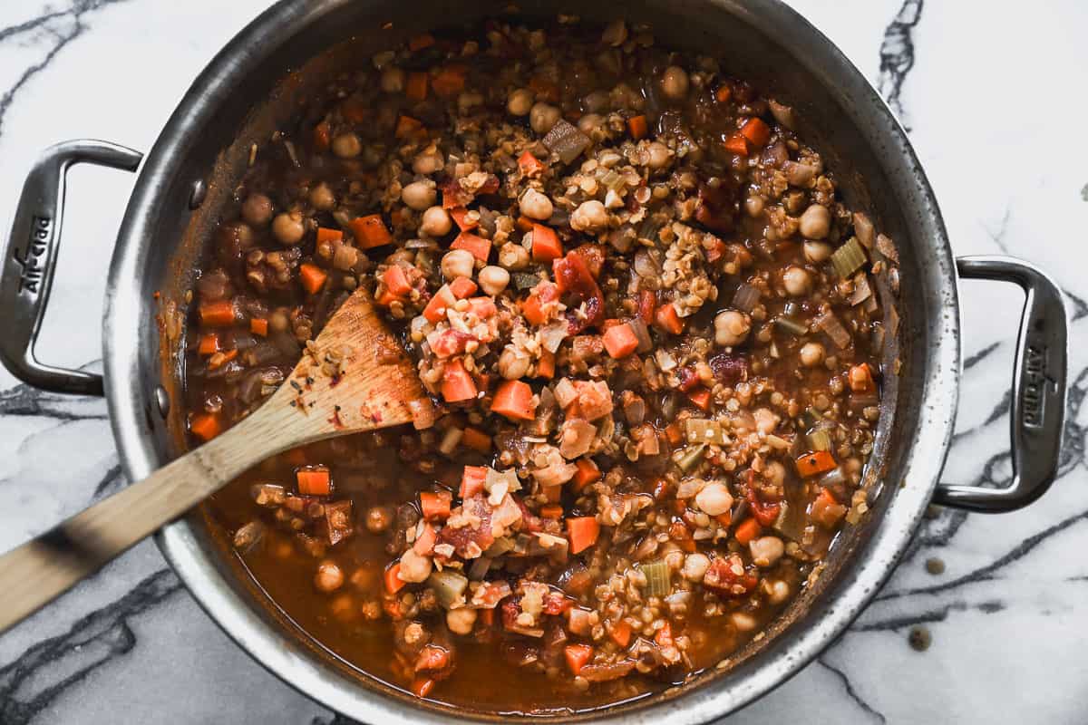 A red lentil soup recipe simmering in a large pot.