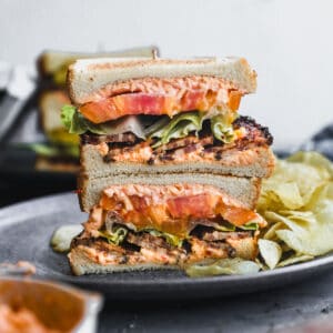 An easy Pimento Cheese BLT sliced in half and stacked on top of each other.