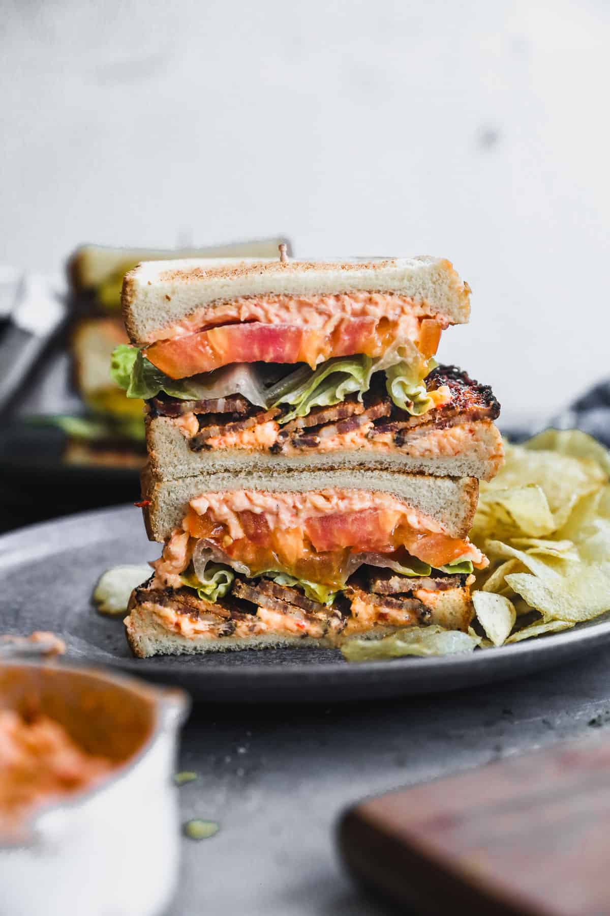 An easy Pimento Cheese BLT sliced in half and stacked on top of each other.
