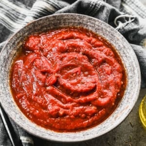 A bowl of homemade Pizza Sauce, ready to be spread on a pizza crust.
