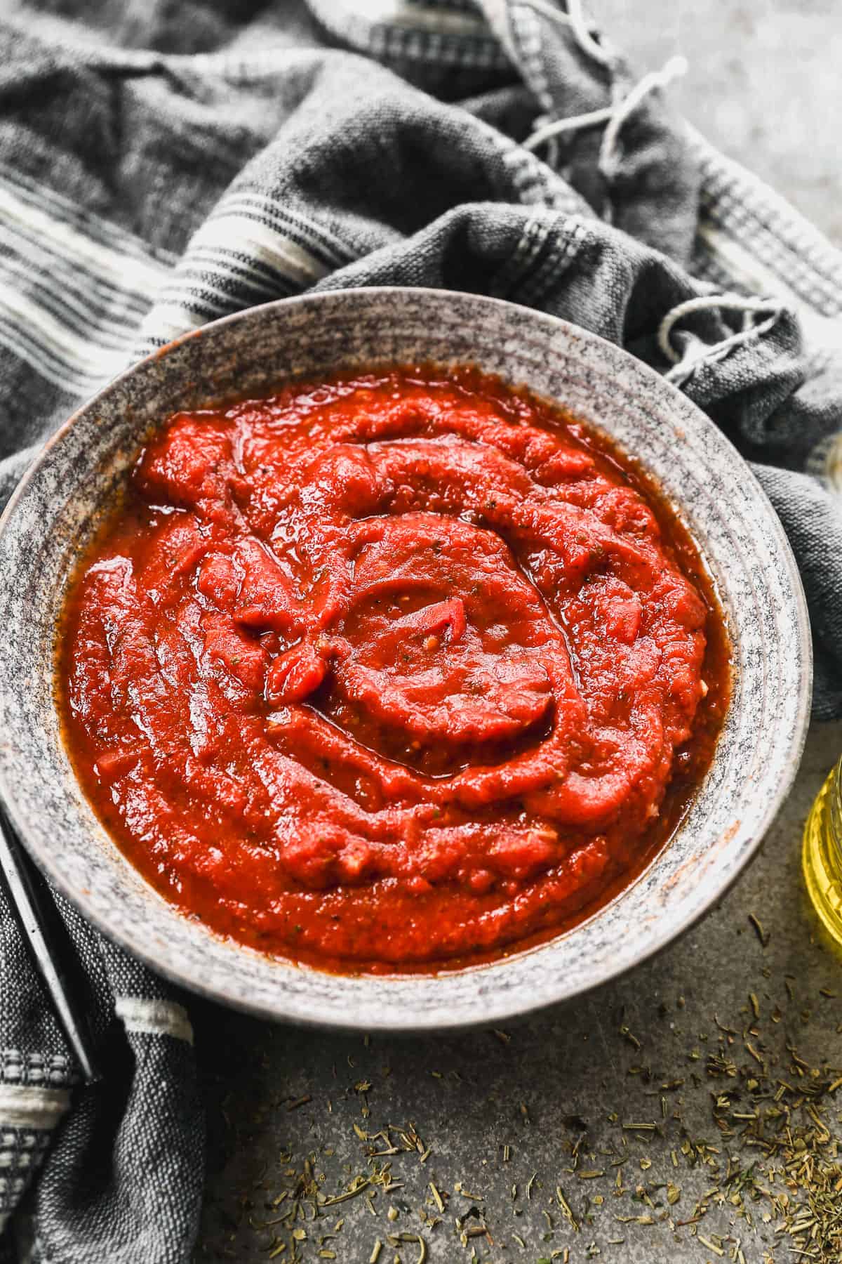 A bowl of homemade Pizza Sauce, ready to be spread on a pizza crust.