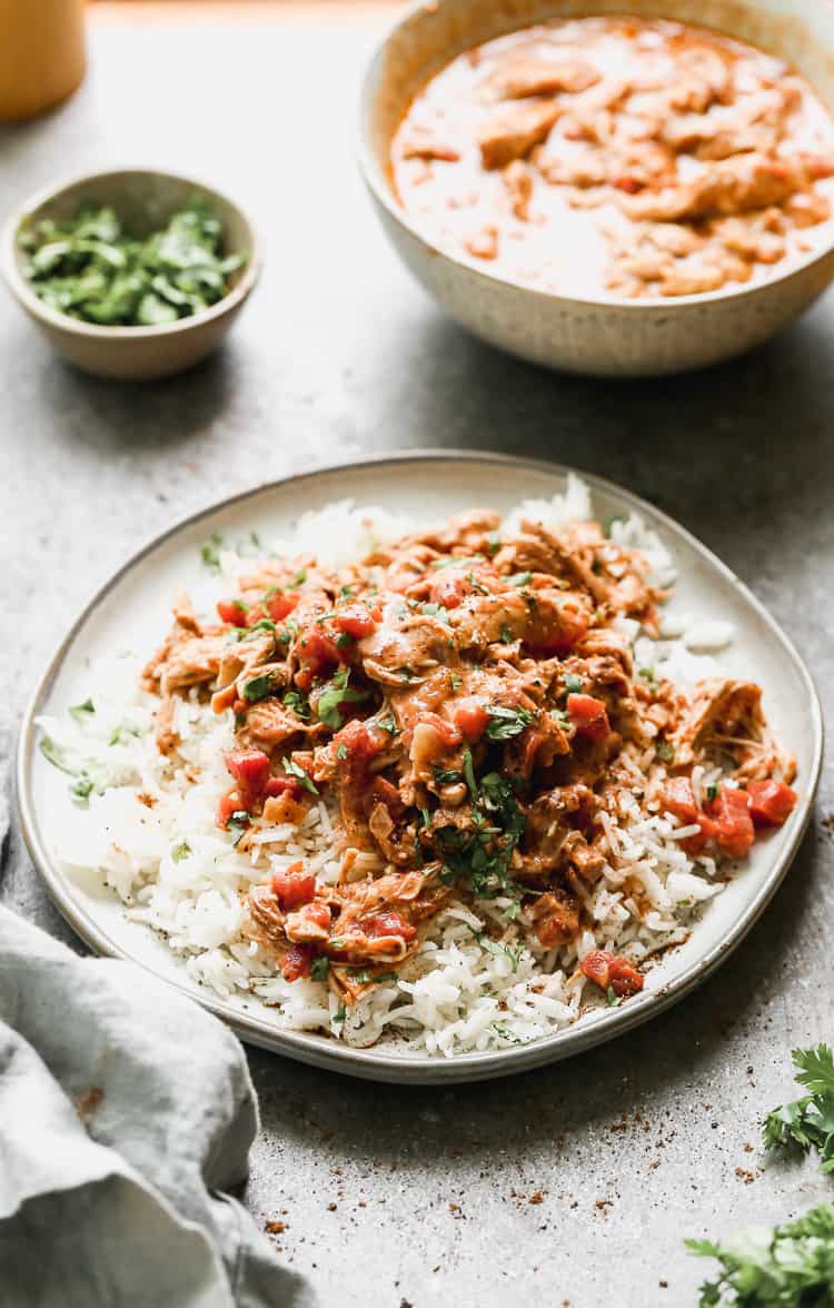 A slow cooker chicken tikka masala recipe with coconut milk, garnished with cilantro and served over basmati rice.