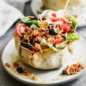 This easy Taco Salad recipe is loaded with fresh ingredients in a crunchy tortilla bowl. It's fundeliciousand perfect for everyone to build their own bowls!