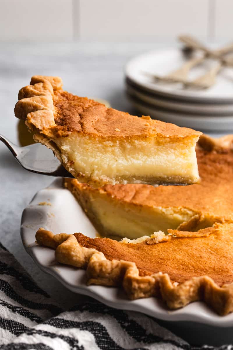 A piece of a lemon chess pie recipe being lifted from the pie plate.