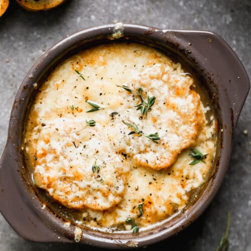 An easy French Onion Soup recipe topped with toasted bread and cheese, ready to eat.
