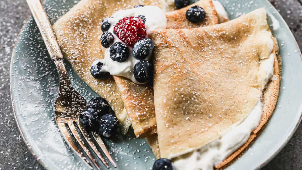 This simple crepe recipe uses pantry ingredients and is ready to enjoy in less than 30 minutes! They turn out thin and golden every time and everyone gets to choose their own toppings.