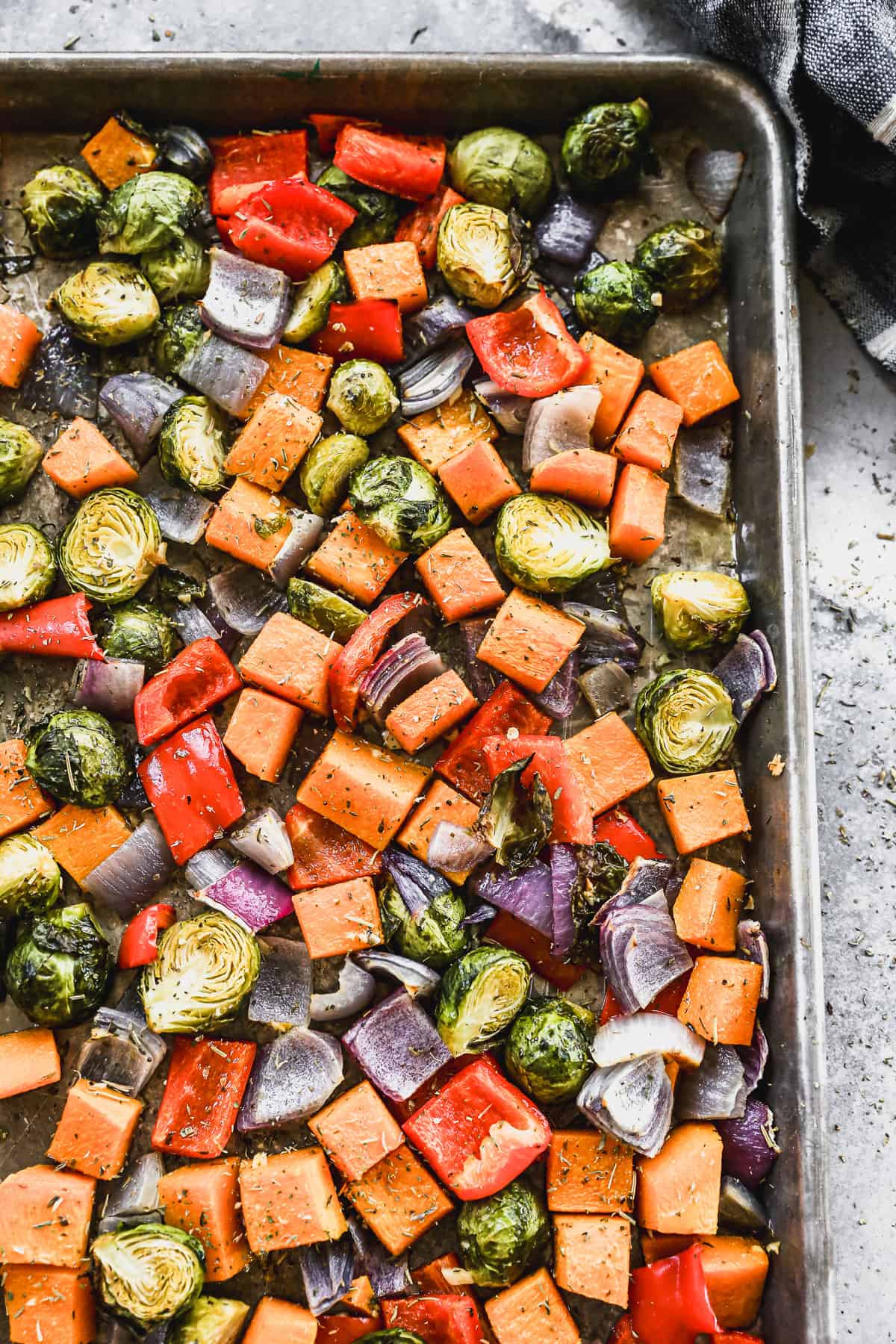 Crispy roasted vegetables on a sheet pan, fresh out of the oven.