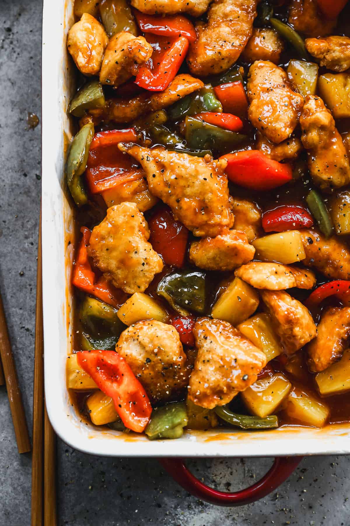 Sweet and Sour Chicken with pineapple and bell peppers in a large dish, ready to serve.