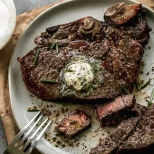 This Air Fryer T-Bone Steak recipe tastes like it came off the grill! It has that seared crust while staying juicy inside. Top it with a quick herb better for a truly gourmet meal in 20 minutes!