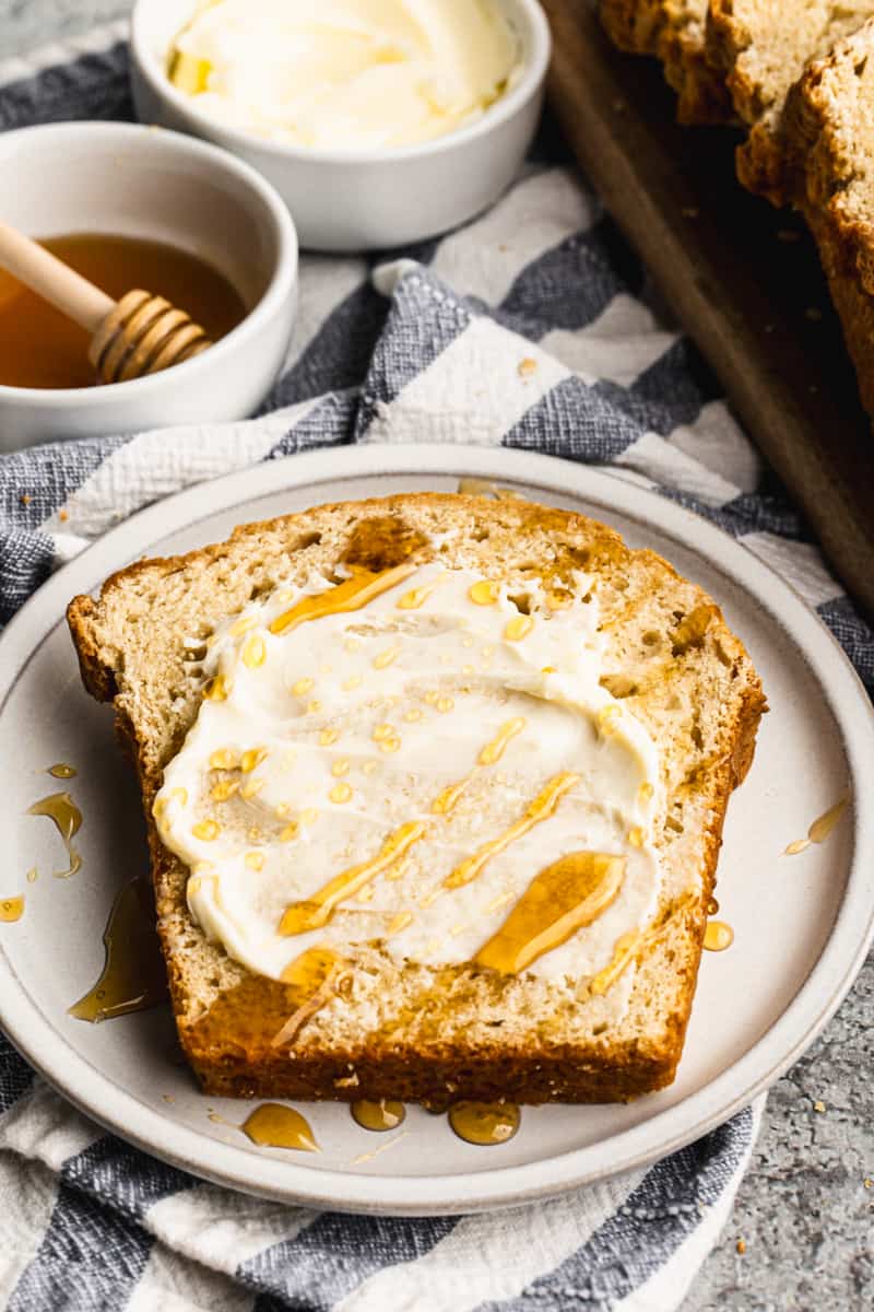 A slice of the best beer bread, slathered with butter and honey.