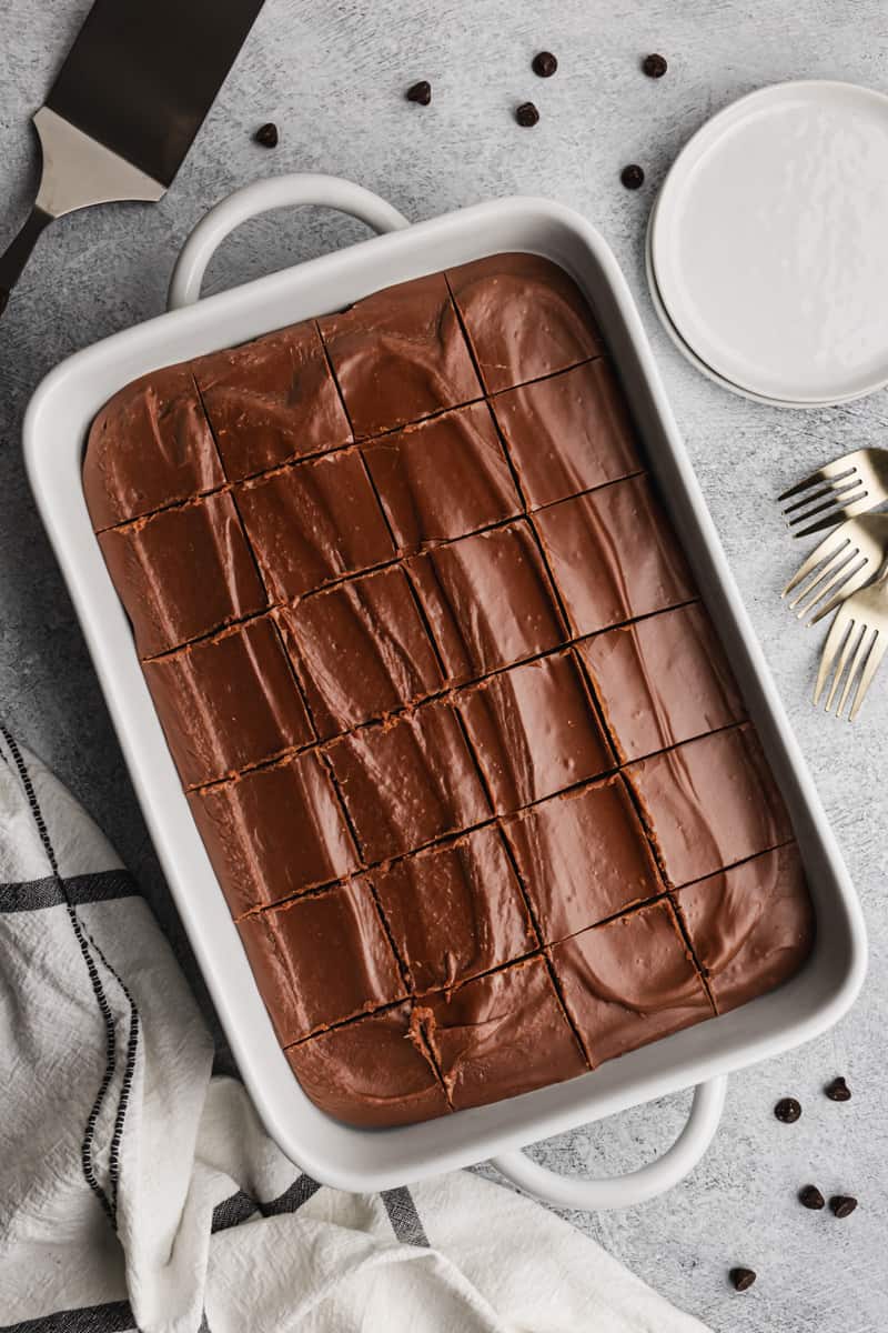 A homemade Mayonnaise Cake recipe covered in a chocolate frosting, sliced and ready to serve.