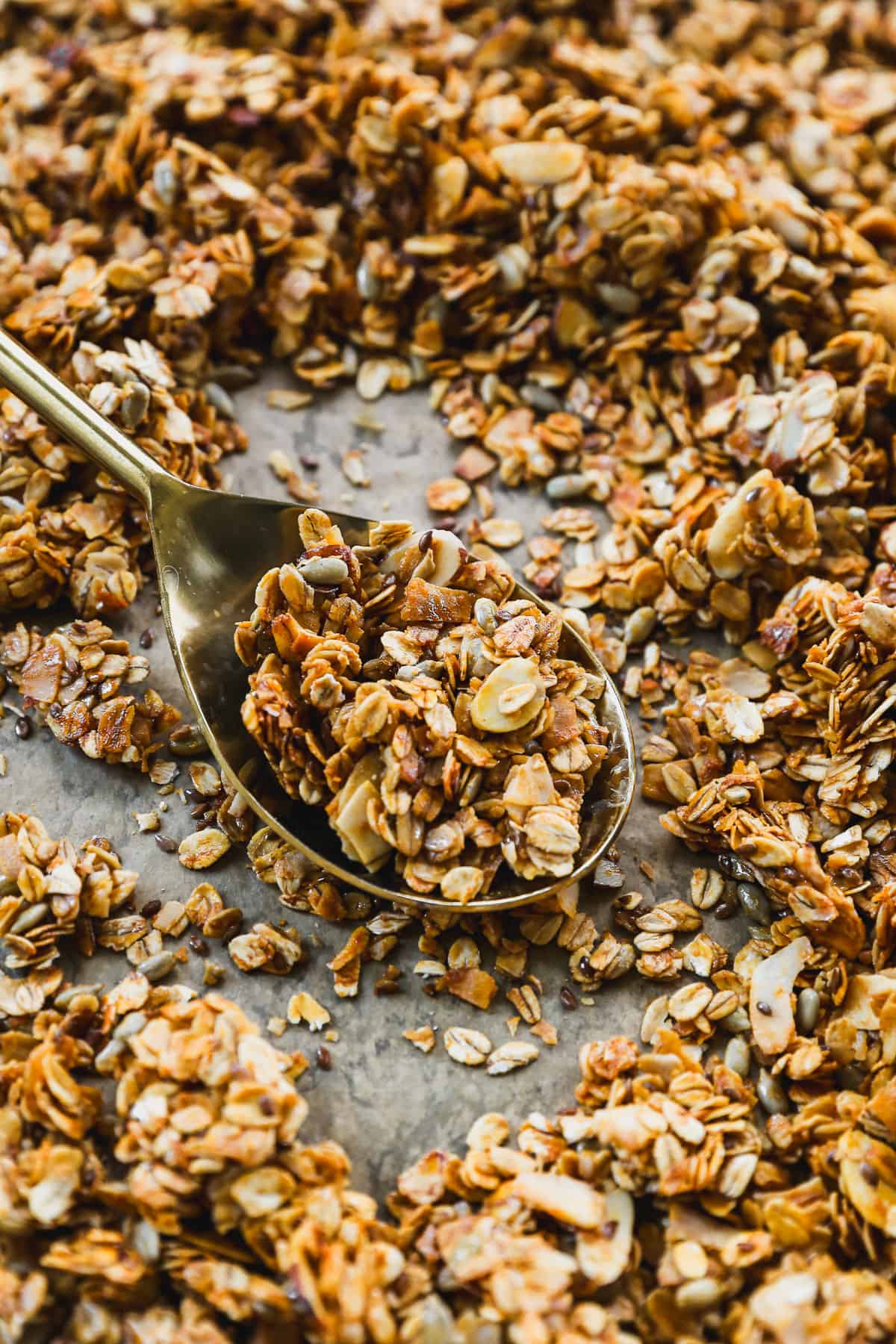 The best honey granola recipe being scooped up with a spoon, ready to enjoy. 
