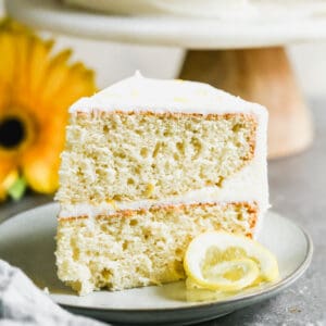 A slice of an easy lemon cake recipe with a homemade lemon buttercream frosting.