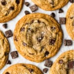 The best Browned Butter Chocolate Chip cookies recipe freshly baked on a piece of parchment paper, sprinkled with sea salt.