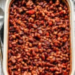 A pan of saucy homemade Baked Beans with bacon, ready to serve.